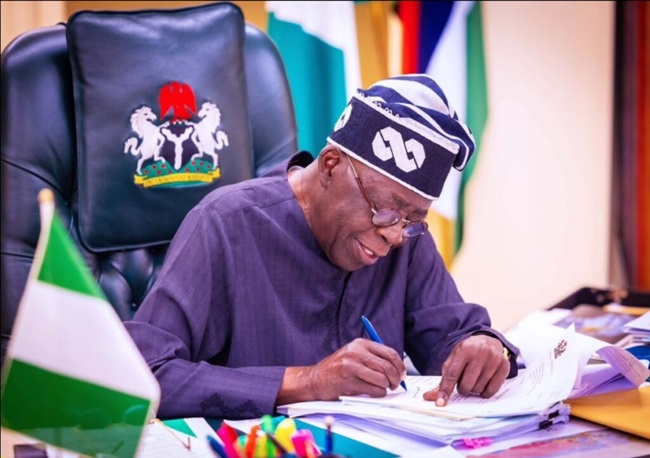 Tinubu-signing-1